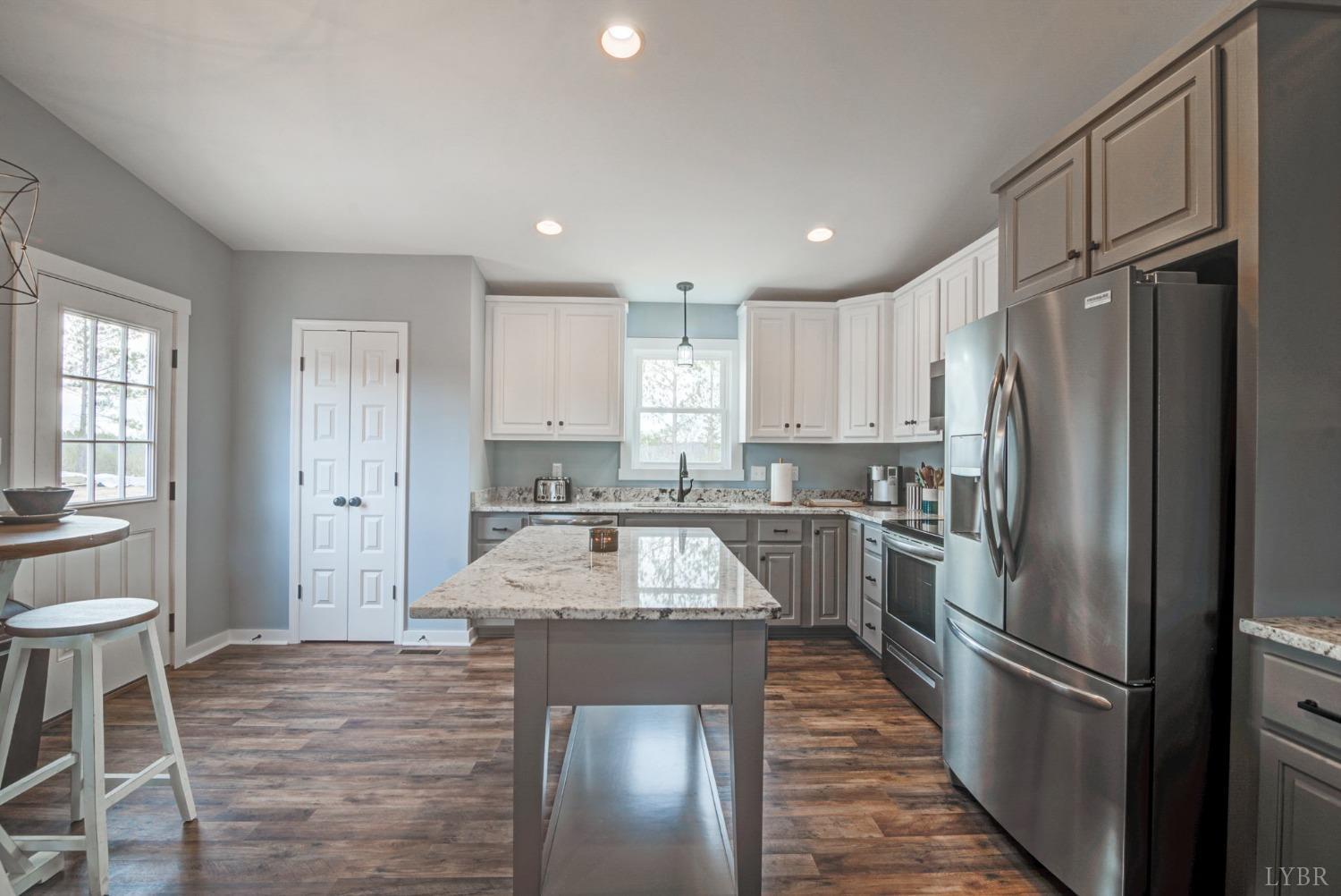 701 Winfall Road Rustburg, VA 24554 - Photo 11 of 38 a kitchen with a refrigerator sink and cabinets