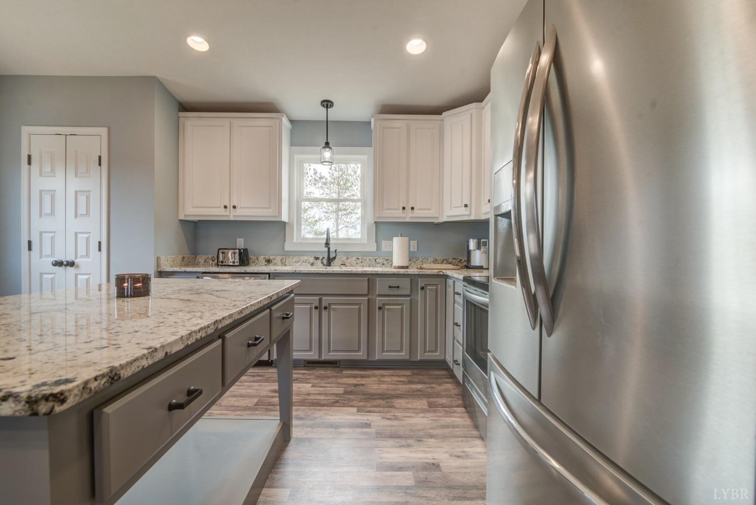 701 Winfall Road Rustburg, VA 24554 - Photo 12 of 38 a kitchen with stainless steel appliances granite countertop a refrigerator sink and white cabinets
