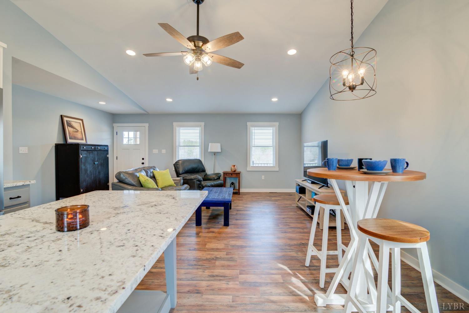 701 Winfall Road Rustburg, VA 24554 - Photo 14 of 38 a view of a dining room with furniture a chandelier and wooden floor