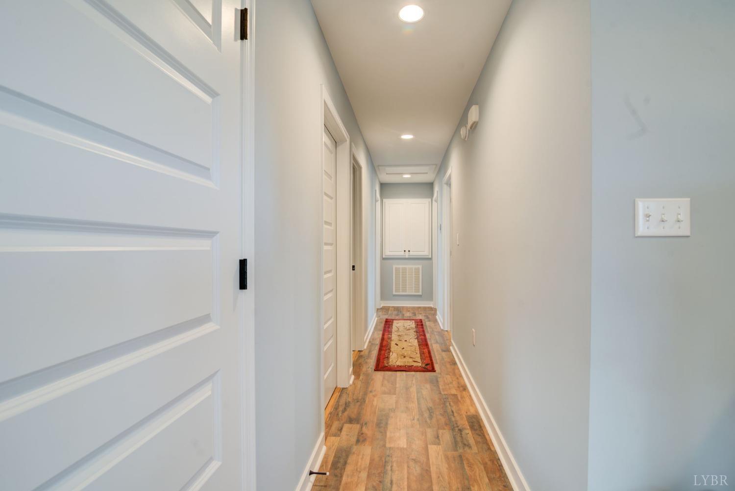 701 Winfall Road Rustburg, VA 24554 - Photo 15 of 38 a view of a hallway with wooden floor and a bathroom