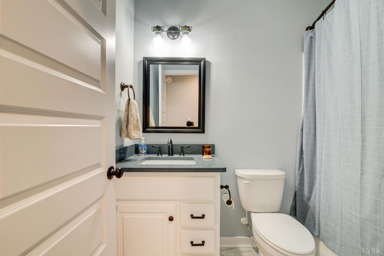 701 Winfall Road Rustburg, VA 24554 - Photo 17 of 38 a bathroom with a toilet sink and mirror