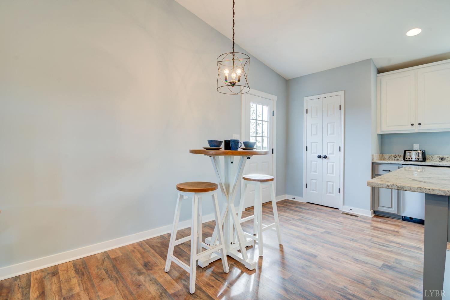 701 Winfall Road Rustburg, VA 24554 - Photo 8 of 38 a view of a kitchen with wooden floor and electronic appliances