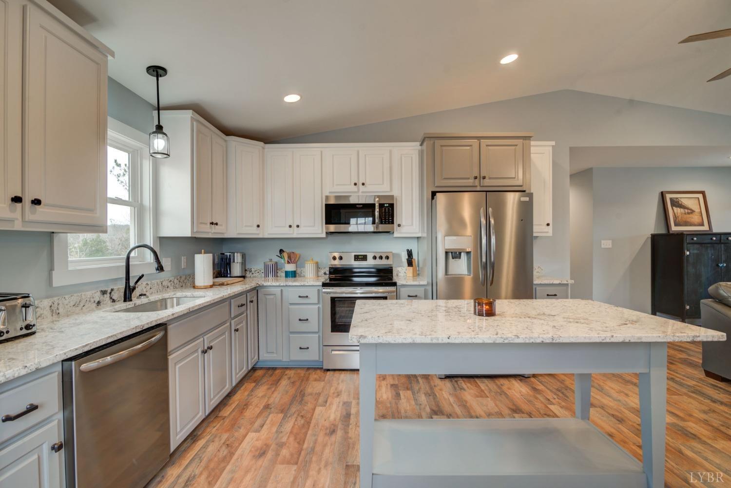 701 Winfall Road Rustburg, VA 24554 - Photo 9 of 38 a large kitchen with granite countertop a sink stainless steel appliances and cabinets