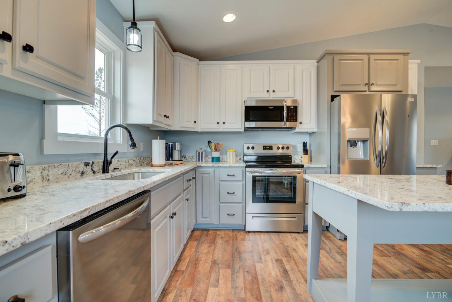701 Winfall Road Rustburg, VA 24554 - Photo 10 of 38 a kitchen with granite countertop a sink stainless steel appliances and white cabinets