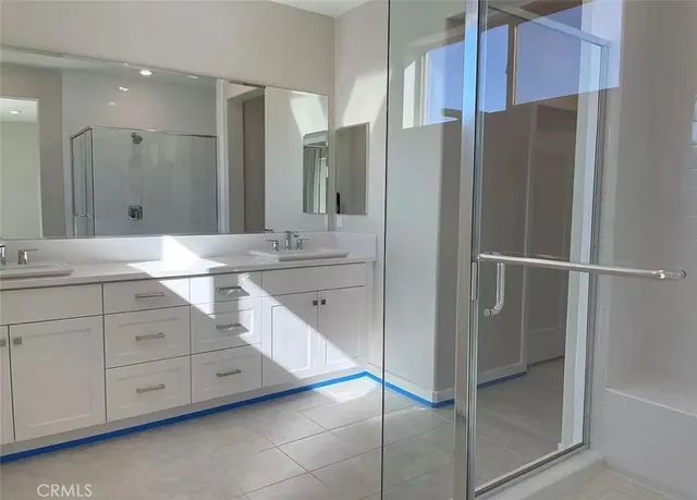 a bathroom with a double vanity sink and mirror