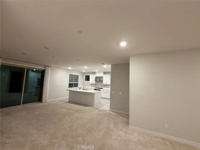 a view of a kitchen with a sink and a refrigerator