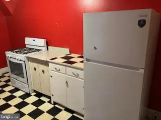 a kitchen with a stove and a refrigerator