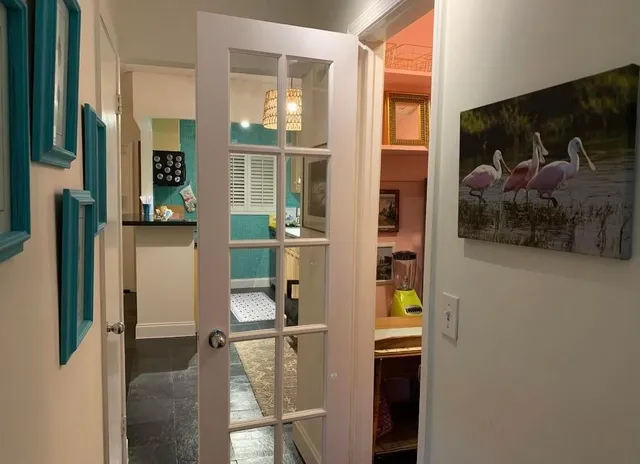 hallway with wooden floor and dining room view