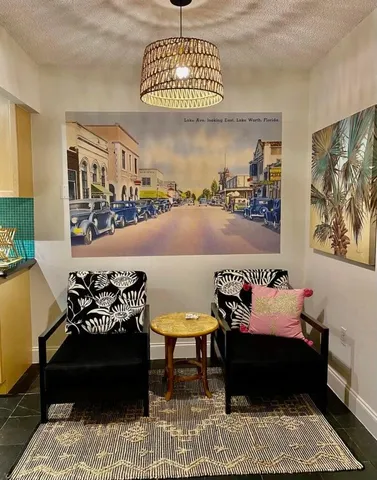 a bedroom with furniture and a painting on the wall