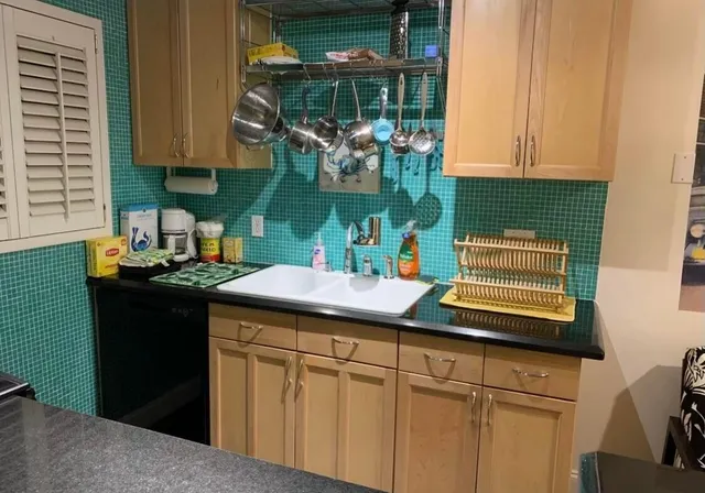 a kitchen with a sink cabinets and a window