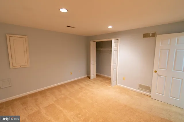 a view of an empty room with a fireplace and a window