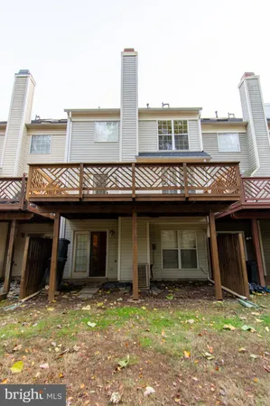 a view of a hallway with wooden floor and entryway