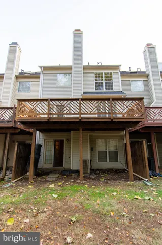 a view of a hallway with wooden floor and entryway