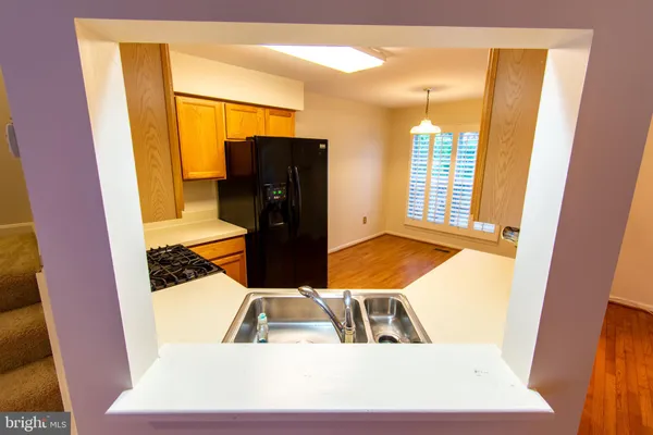 a kitchen with stainless steel appliances a refrigerator and a stove top oven