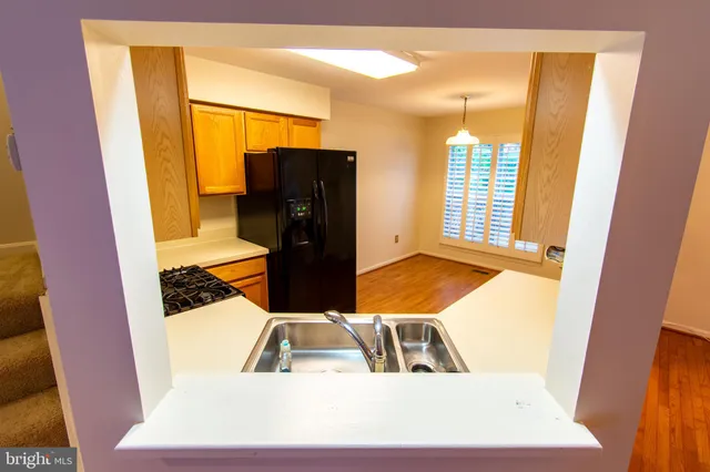 a kitchen with stainless steel appliances a refrigerator and a stove top oven