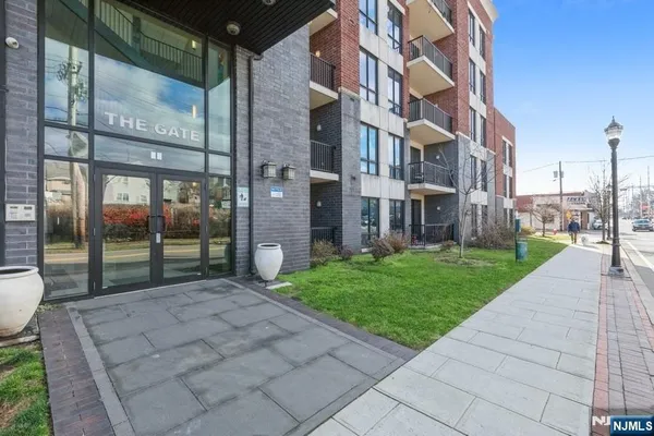 a view of a brick building next to a yard