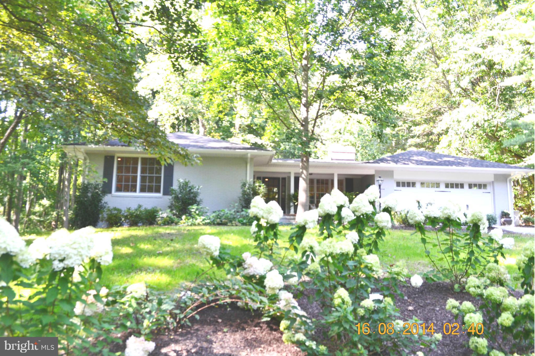 4242 Butler Road Glyndon, MD 21136 - Photo 2 of 29 a backyard of a house with table and chairs and potted plants
