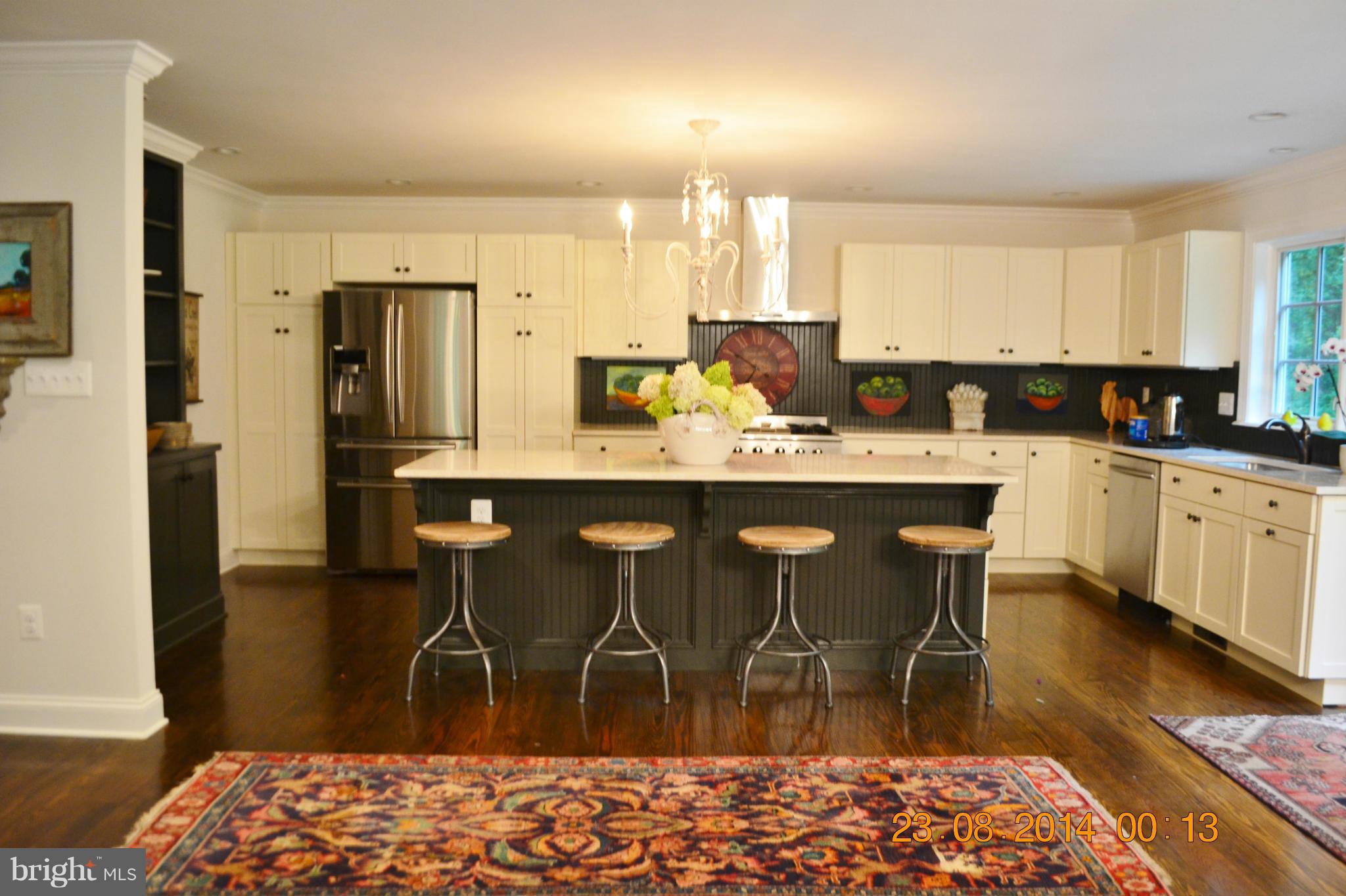 4242 Butler Road Glyndon, MD 21136 - Photo 12 of 29 a kitchen with stainless steel appliances kitchen island granite countertop a sink and cabinets