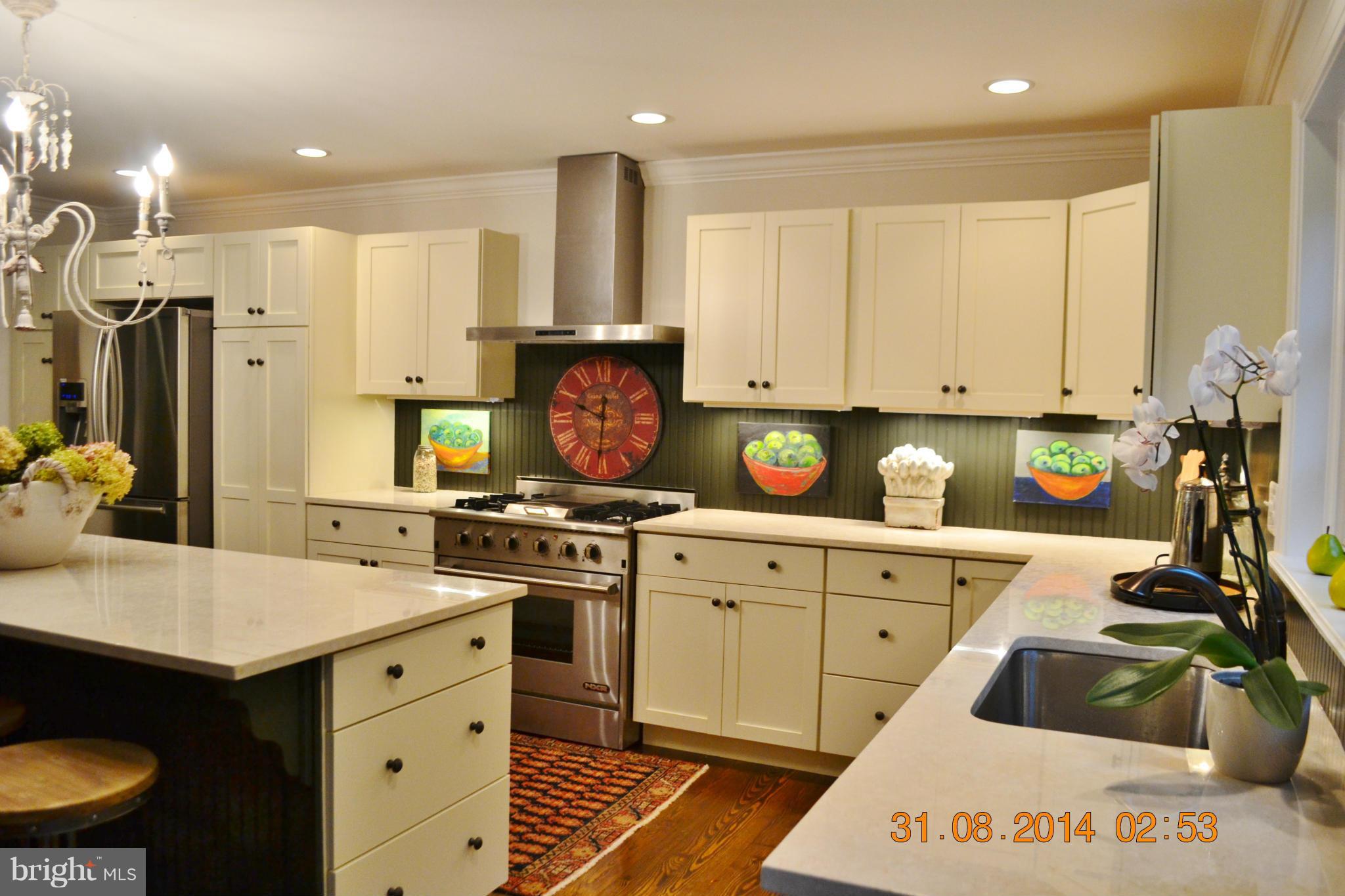 4242 Butler Road Glyndon, MD 21136 - Photo 13 of 29 a kitchen with a stove a sink and a refrigerator
