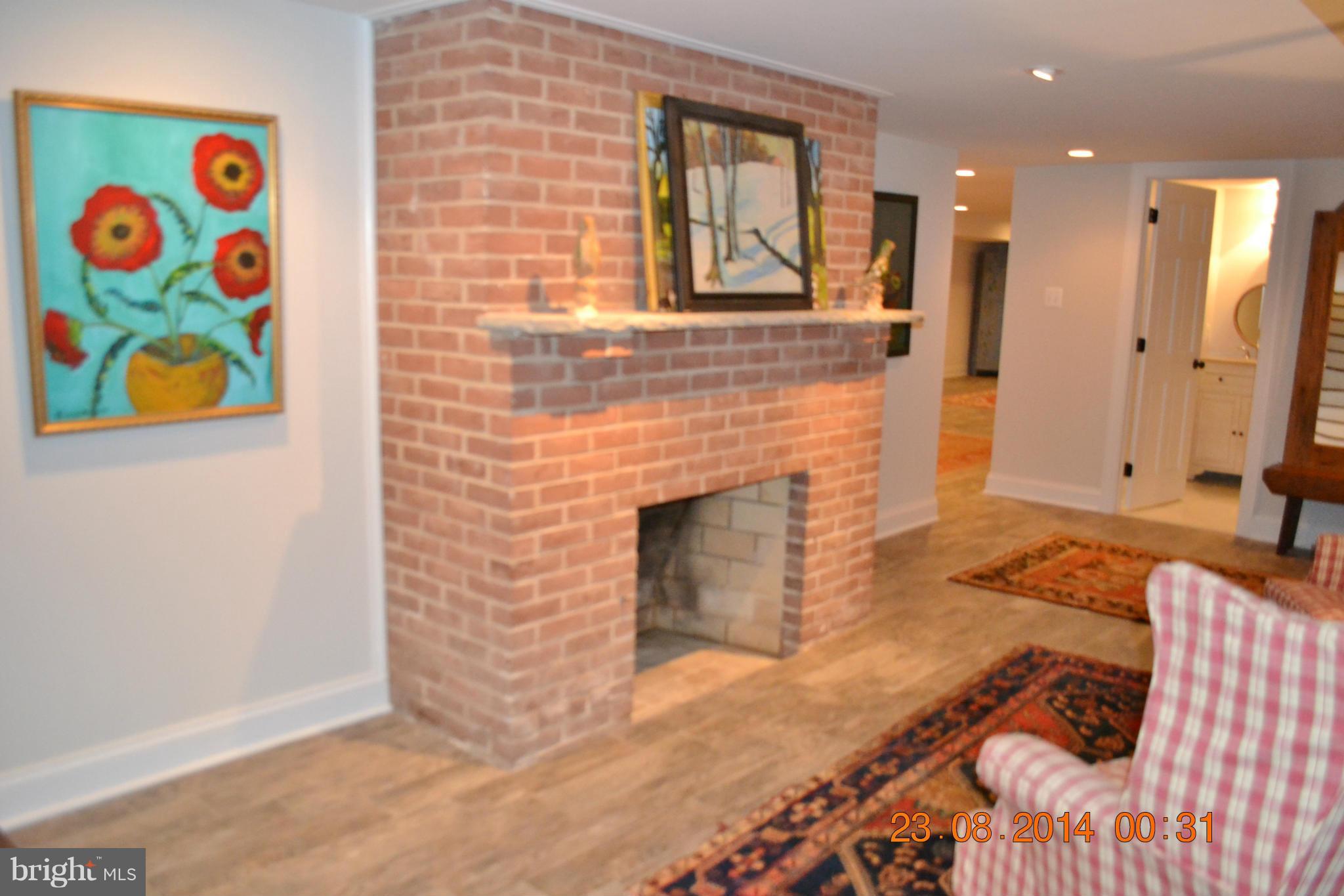 4242 Butler Road Glyndon, MD 21136 - Photo 23 of 29 a bedroom with a bed and a fireplace