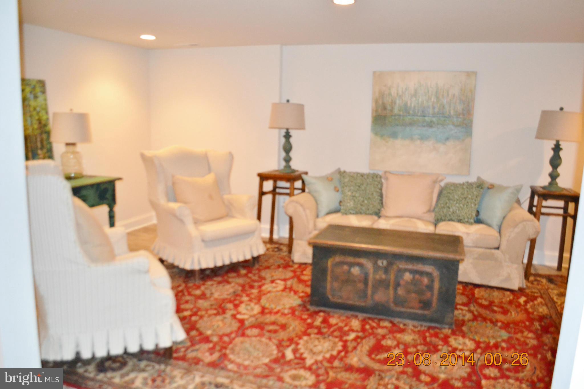 4242 Butler Road Glyndon, MD 21136 - Photo 24 of 29 a living room with furniture a couch and a chandelier