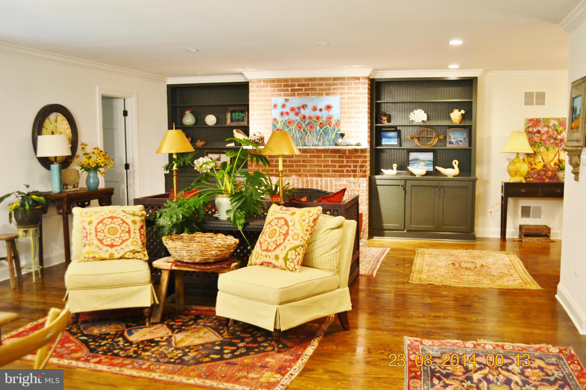 4242 Butler Road Glyndon, MD 21136 - Photo 10 of 29 a living room with patio furniture and wooden floor