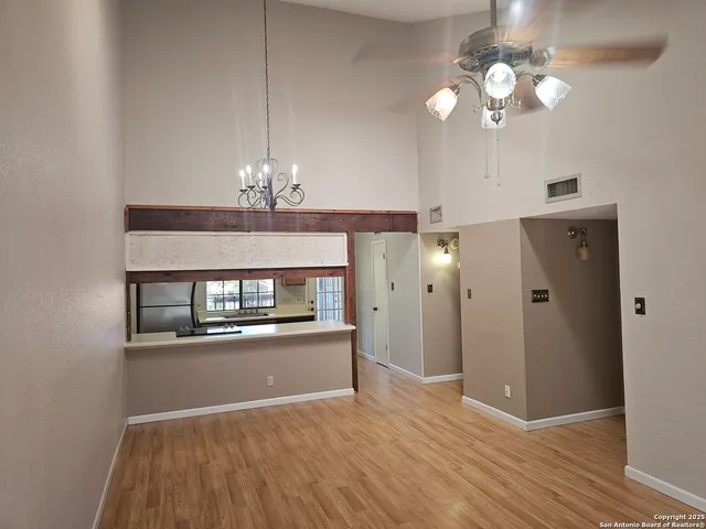 a view of a room with chandelier and wooden floor