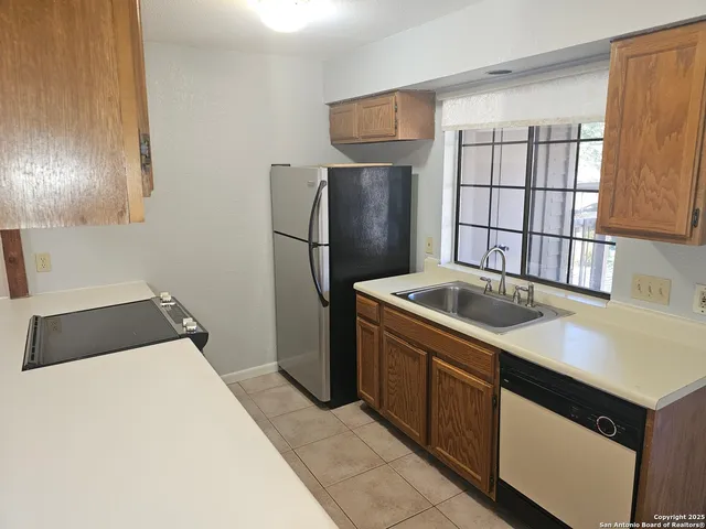 a kitchen with a refrigerator sink and stove