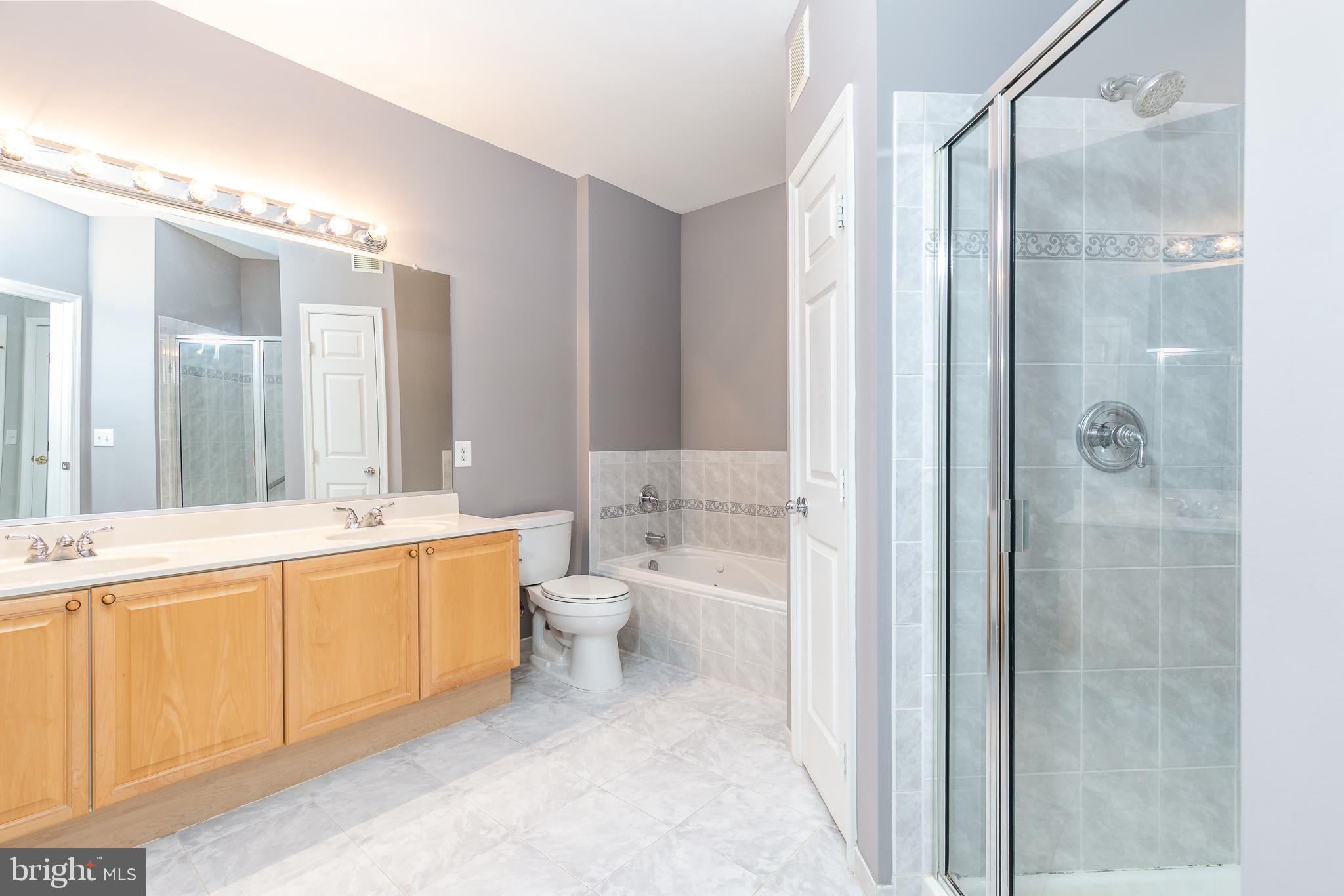 4300 Cannon Ridge Court, Unit 15 Fairfax, VA 22033 - Photo 13 of 24 a large bathroom with a double vanity sink toilet mirror and shower