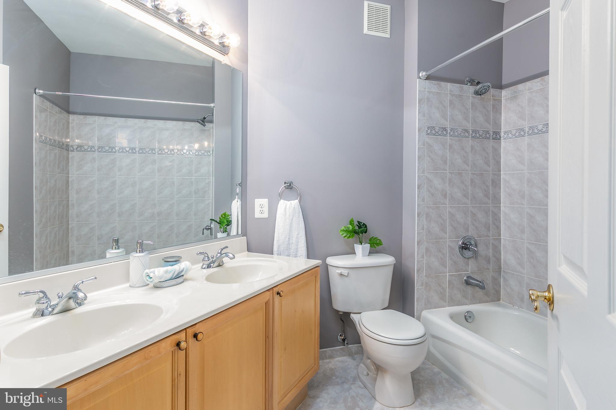 4300 Cannon Ridge Court, Unit 15 Fairfax, VA 22033 - Photo 19 of 24 a bathroom with a granite countertop sink toilet and shower