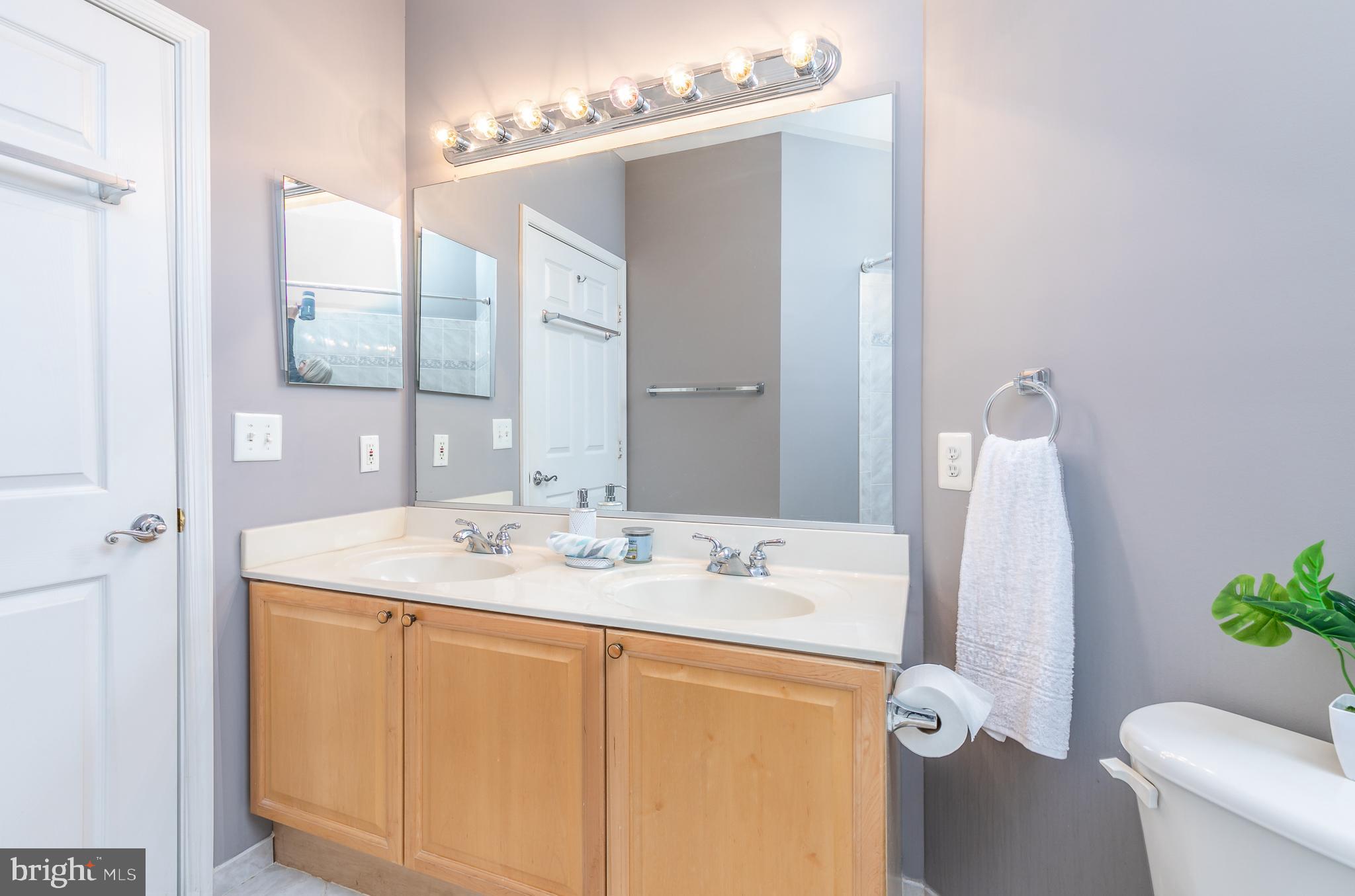 4300 Cannon Ridge Court, Unit 15 Fairfax, VA 22033 - Photo 20 of 24 a bathroom with a sink vanity granite and a mirror