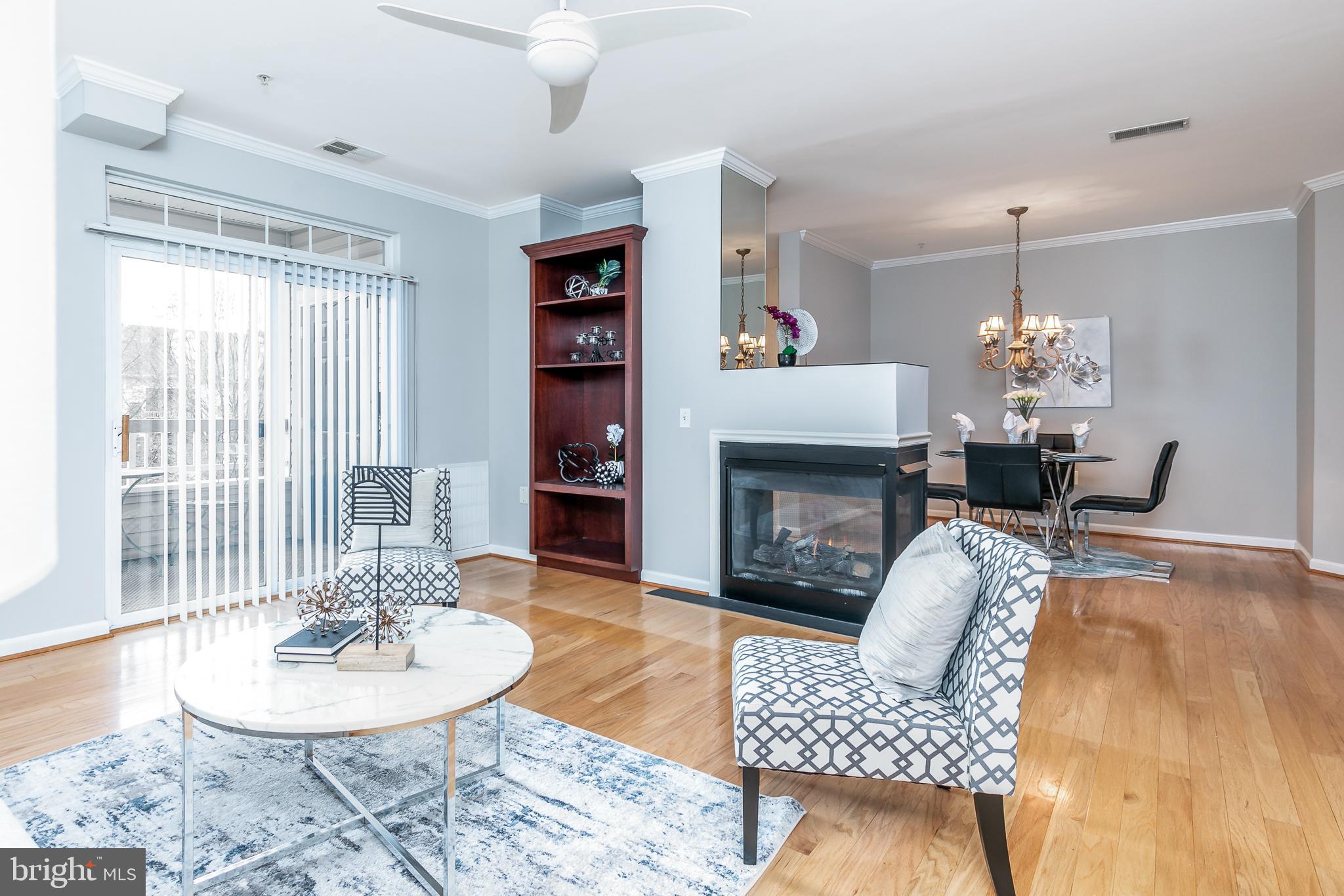4300 Cannon Ridge Court, Unit 15 Fairfax, VA 22033 - Photo 6 of 24 a living room with furniture a fireplace and a chandelier