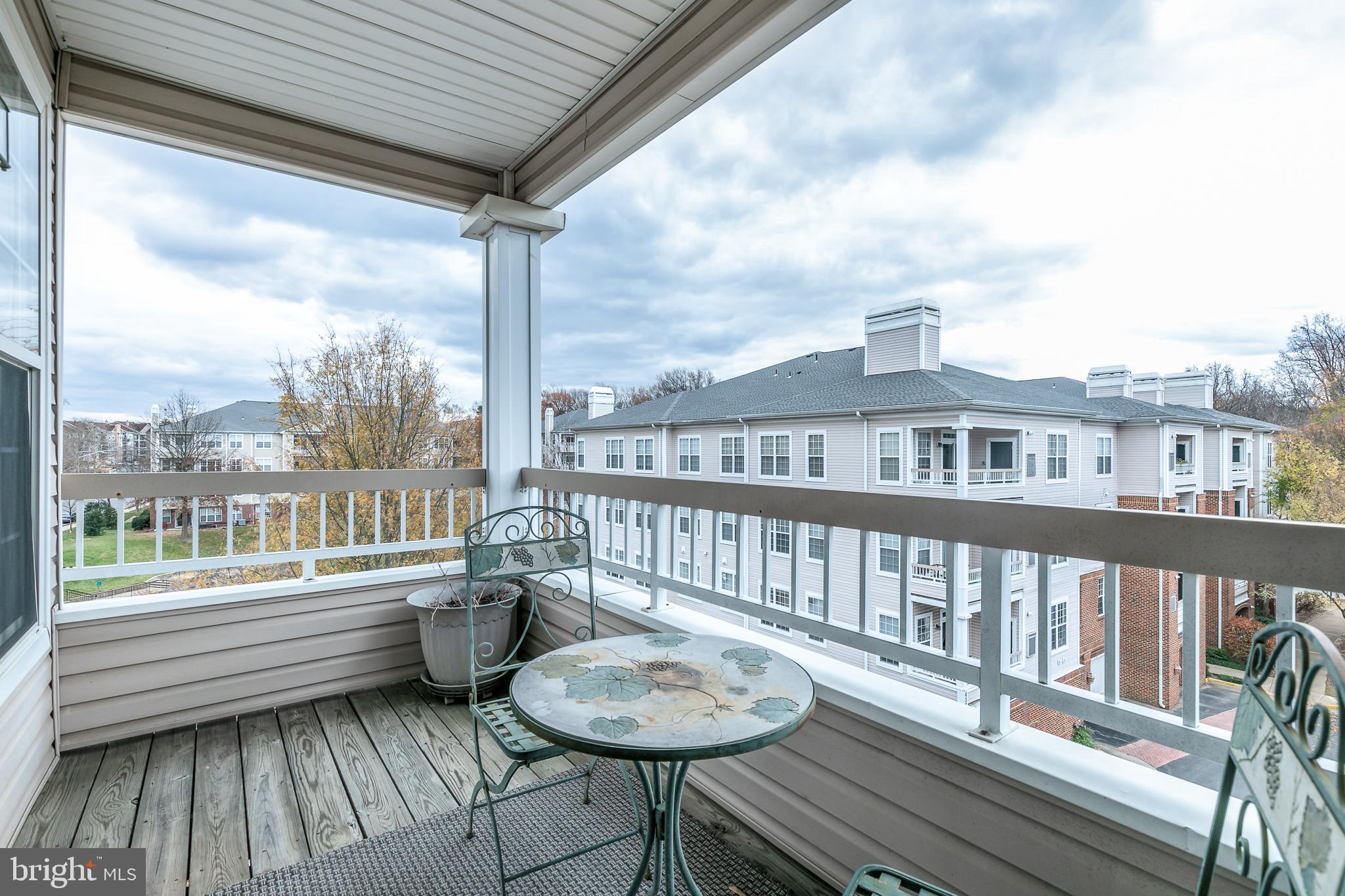 4300 Cannon Ridge Court, Unit 15 Fairfax, VA 22033 - Photo 7 of 24 a balcony with chairs and wooden floor