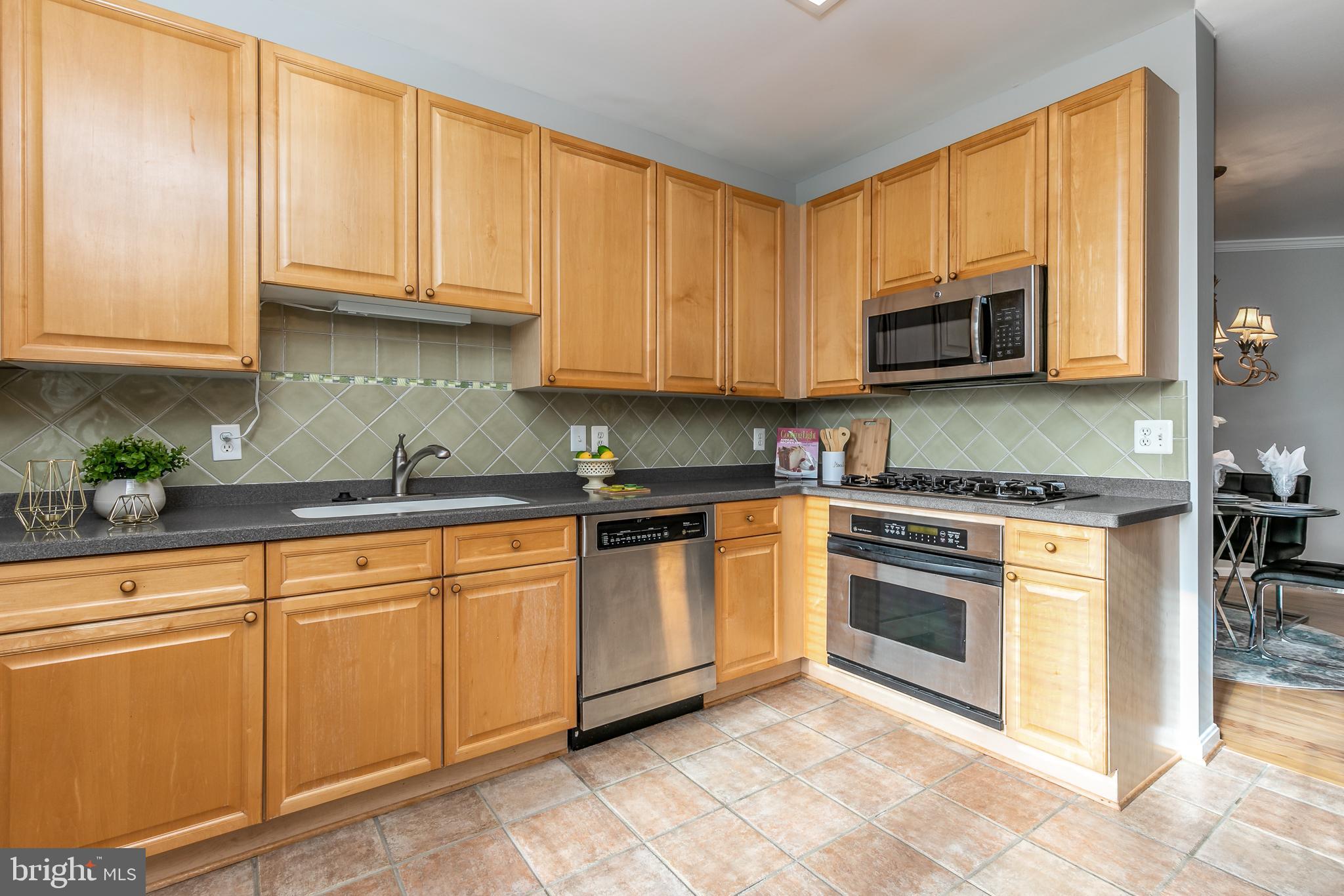 4300 Cannon Ridge Court, Unit 15 Fairfax, VA 22033 - Photo 10 of 24 a kitchen with granite countertop white cabinets stainless steel appliances and a sink