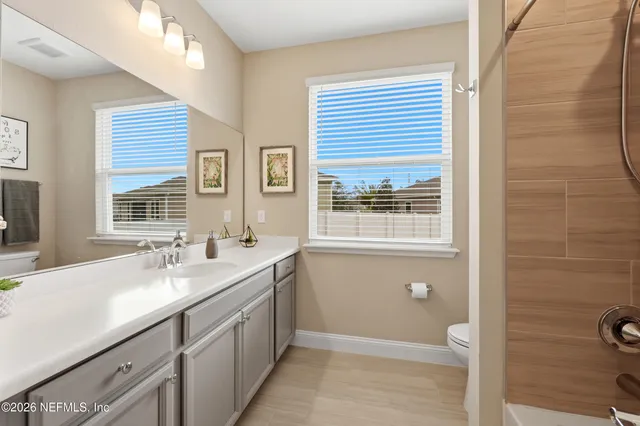 a bedroom with a large bed and a ceiling fan