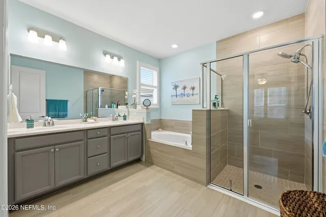 a bathroom with a tub a sink and mirrors