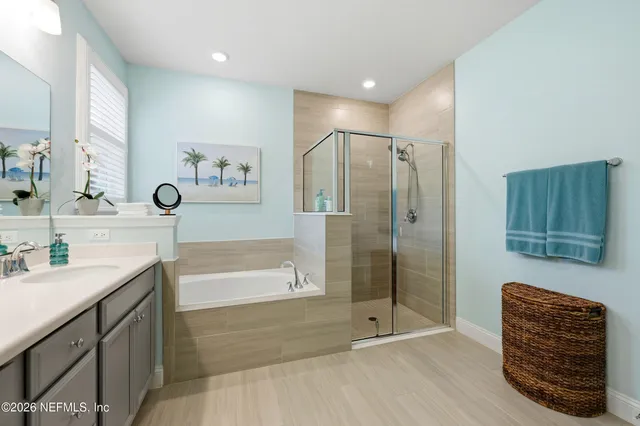 a view of a dining room and livingroom with furniture wooden floor a chandelier