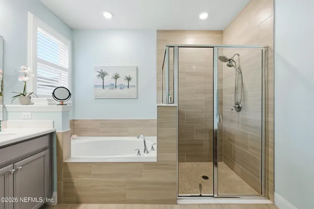 a kitchen with stainless steel appliances kitchen island granite countertop a stove a sink and a refrigerator