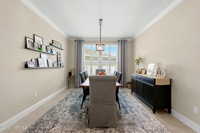 a living room with furniture kitchen and a chandelier