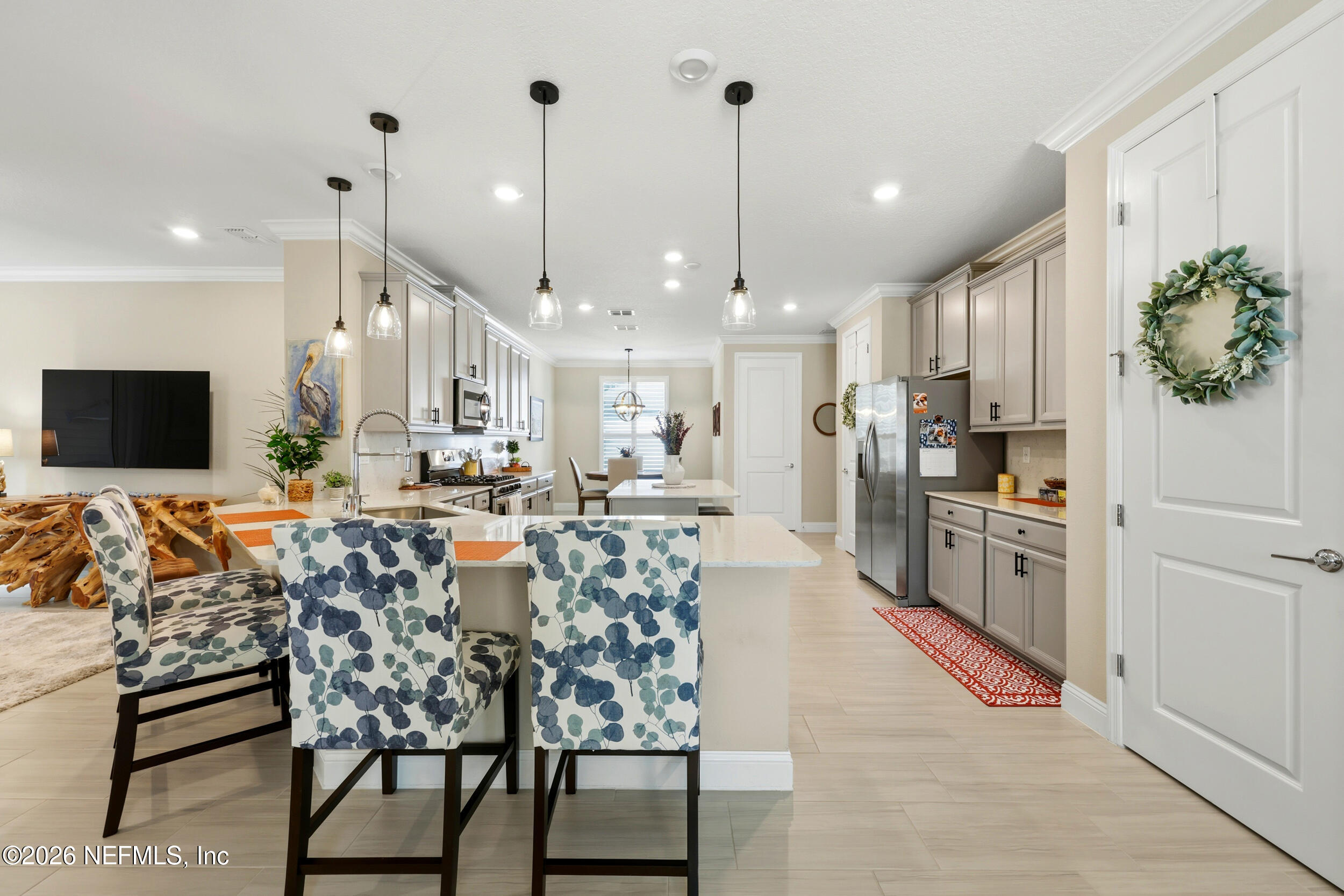 25 Waterbrook Place St. Augustine, FL 32095 - Photo 23 of 55 a kitchen with stainless steel appliances kitchen island granite countertop a stove a sink and a refrigerator
