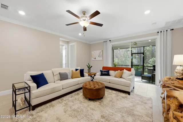 a kitchen with stainless steel appliances granite countertop a sink a stove a refrigerator cabinets and chairs