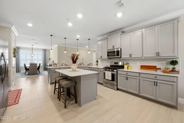 a dining room with furniture window and wooden floor