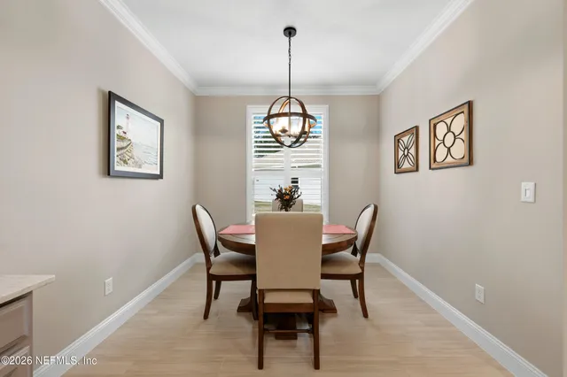 a kitchen with refrigerator cabinets and dining table