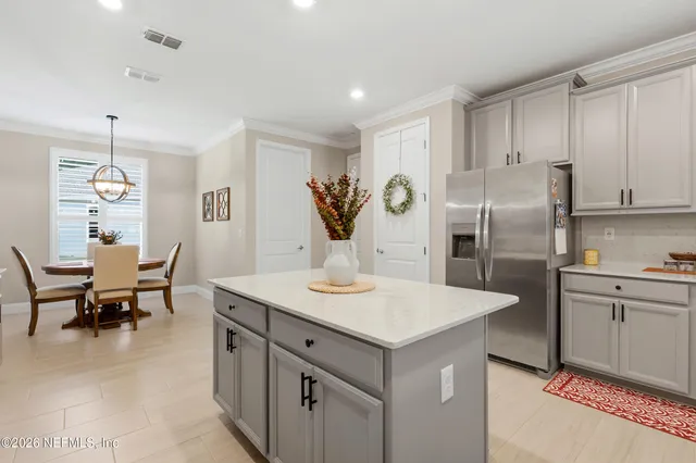 a view of a house with a small yard plants and large tree