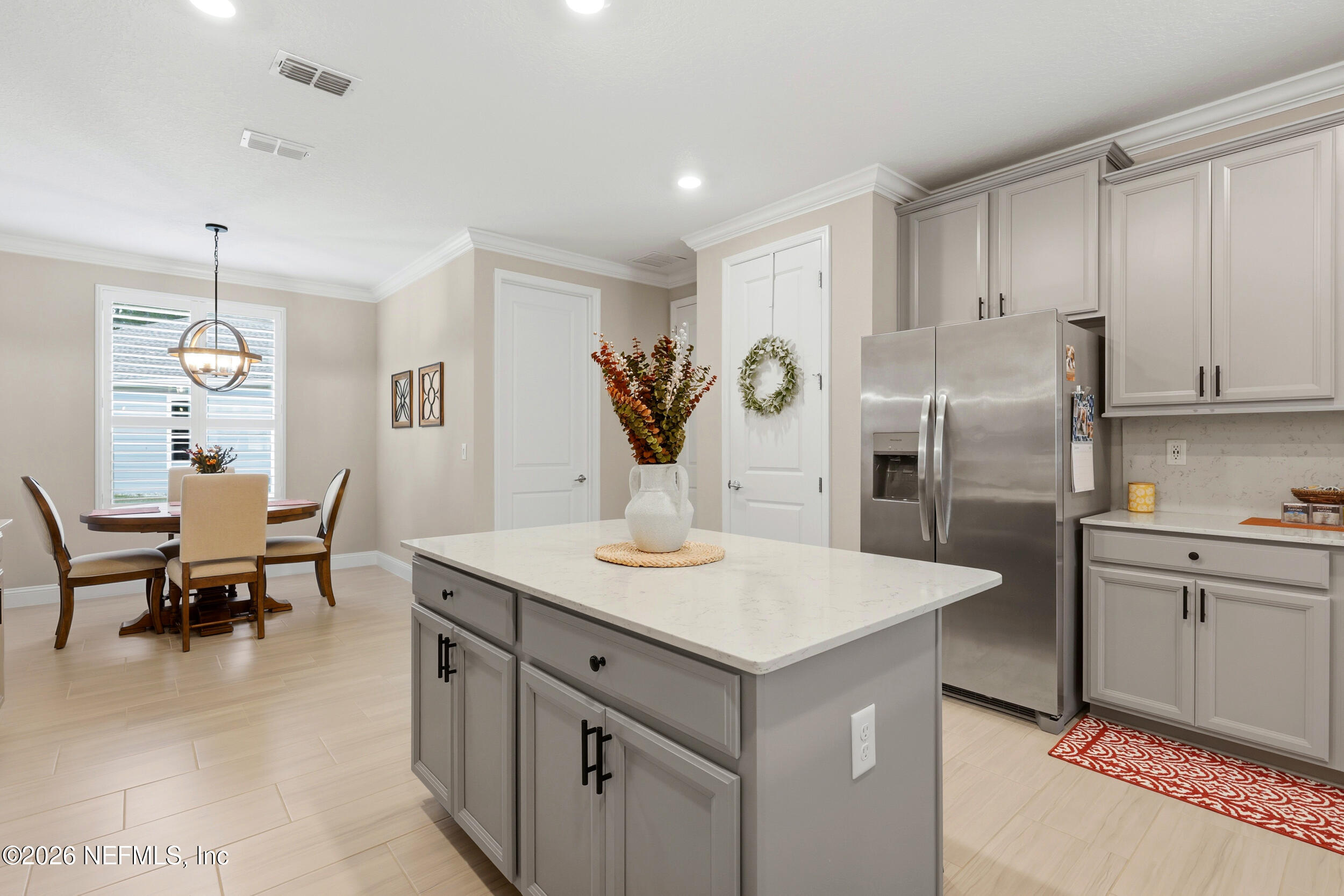 25 Waterbrook Place St. Augustine, FL 32095 - Photo 36 of 55 a kitchen with refrigerator cabinets and dining table