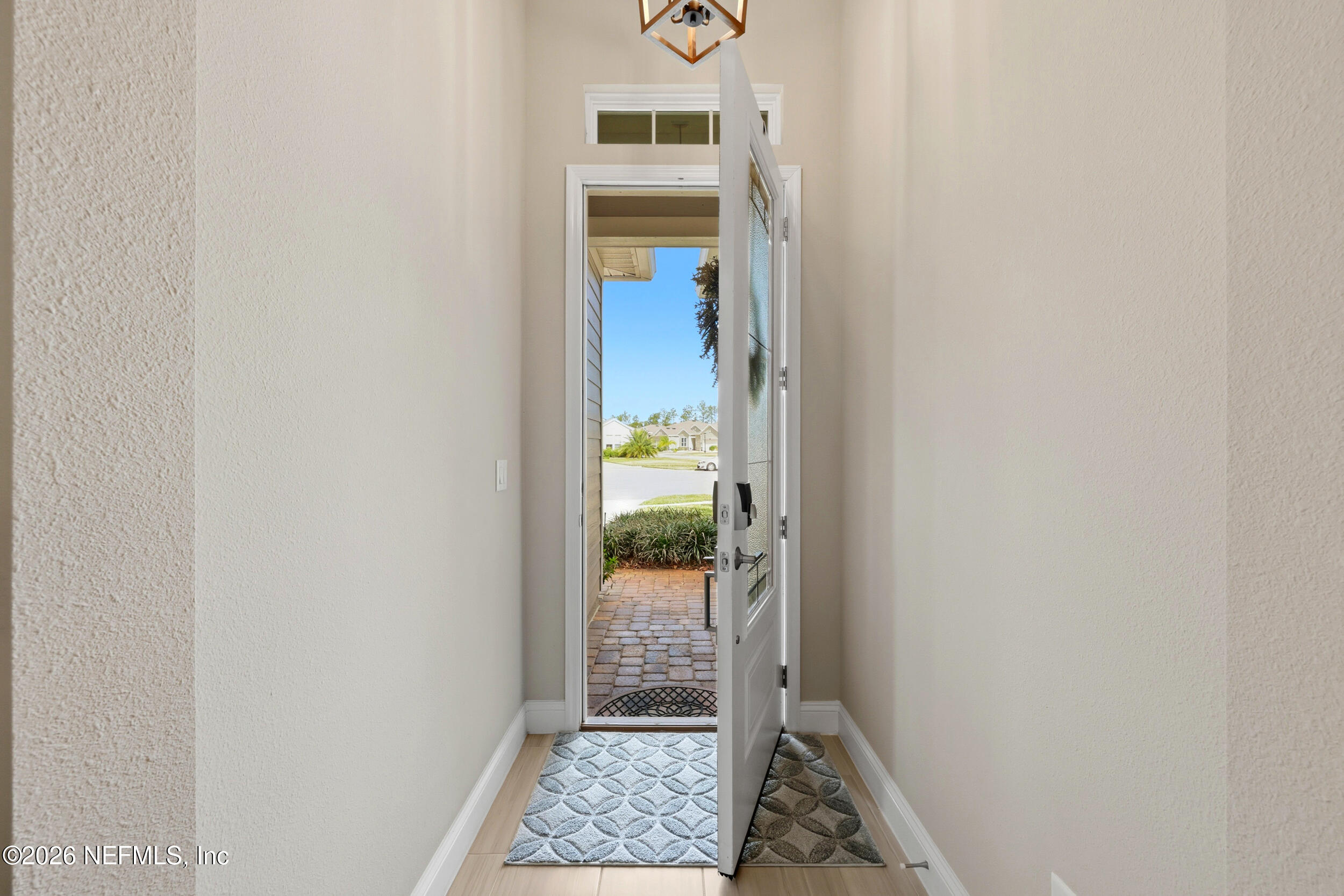 25 Waterbrook Place St. Augustine, FL 32095 - Photo 4 of 55 a view of a hallway with wooden floor and a bathroom