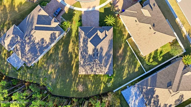 an aerial view of a house with swimming pool and garden