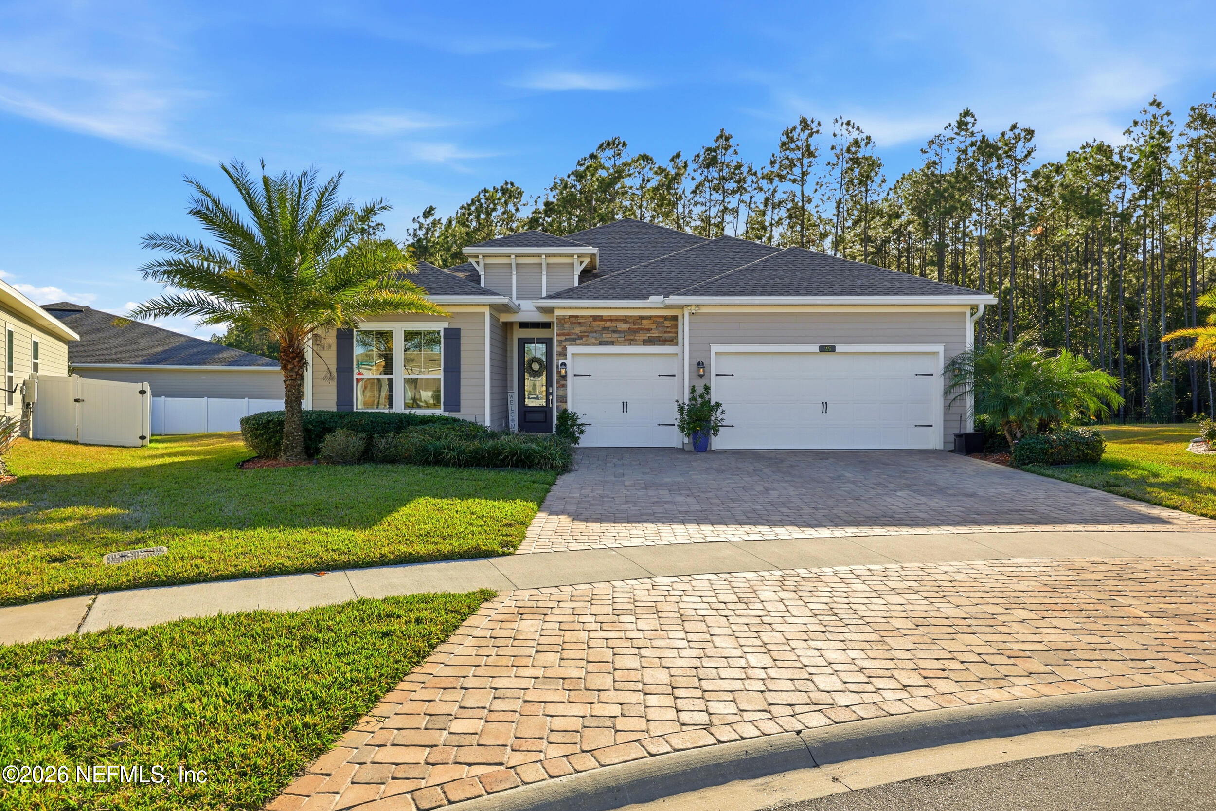 25 Waterbrook Place St. Augustine, FL 32095 - Photo 49 of 55 a view of a white house with a yard plants and palm trees