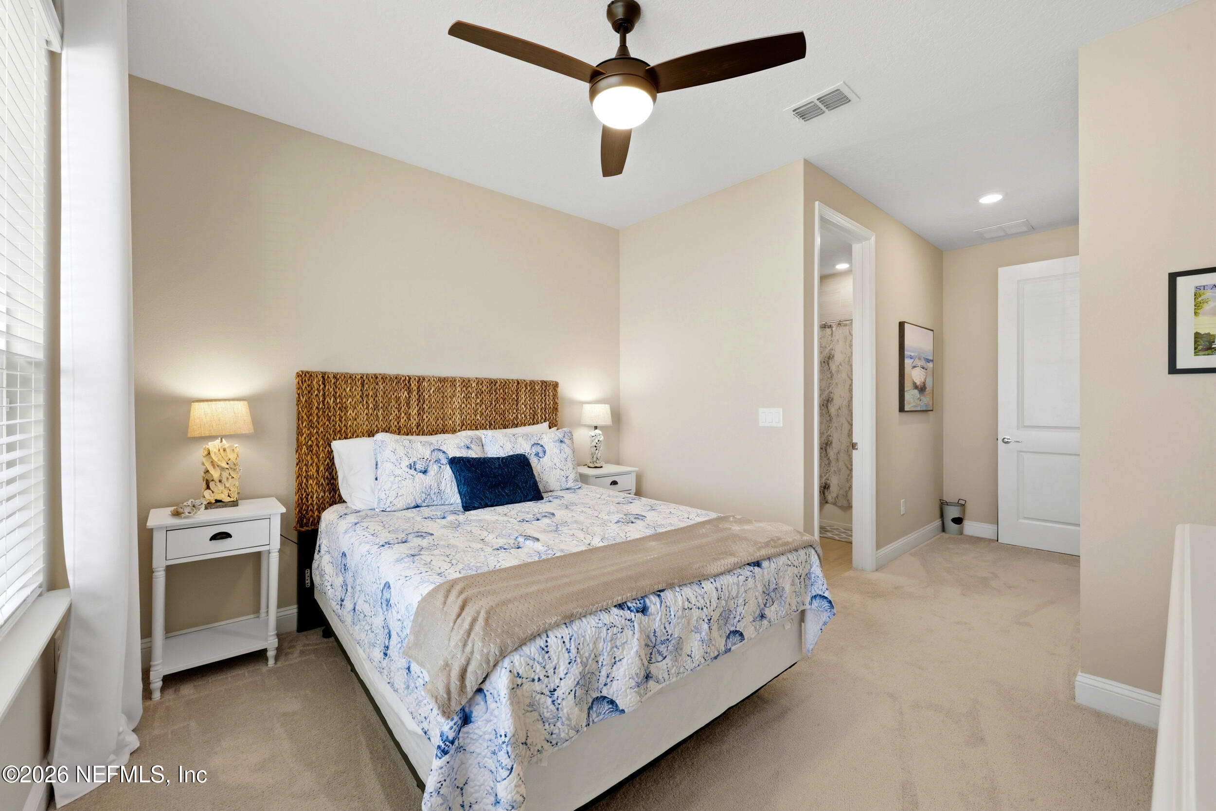 25 Waterbrook Place St. Augustine, FL 32095 - Photo 8 of 55 a bedroom with a bed and a chandelier