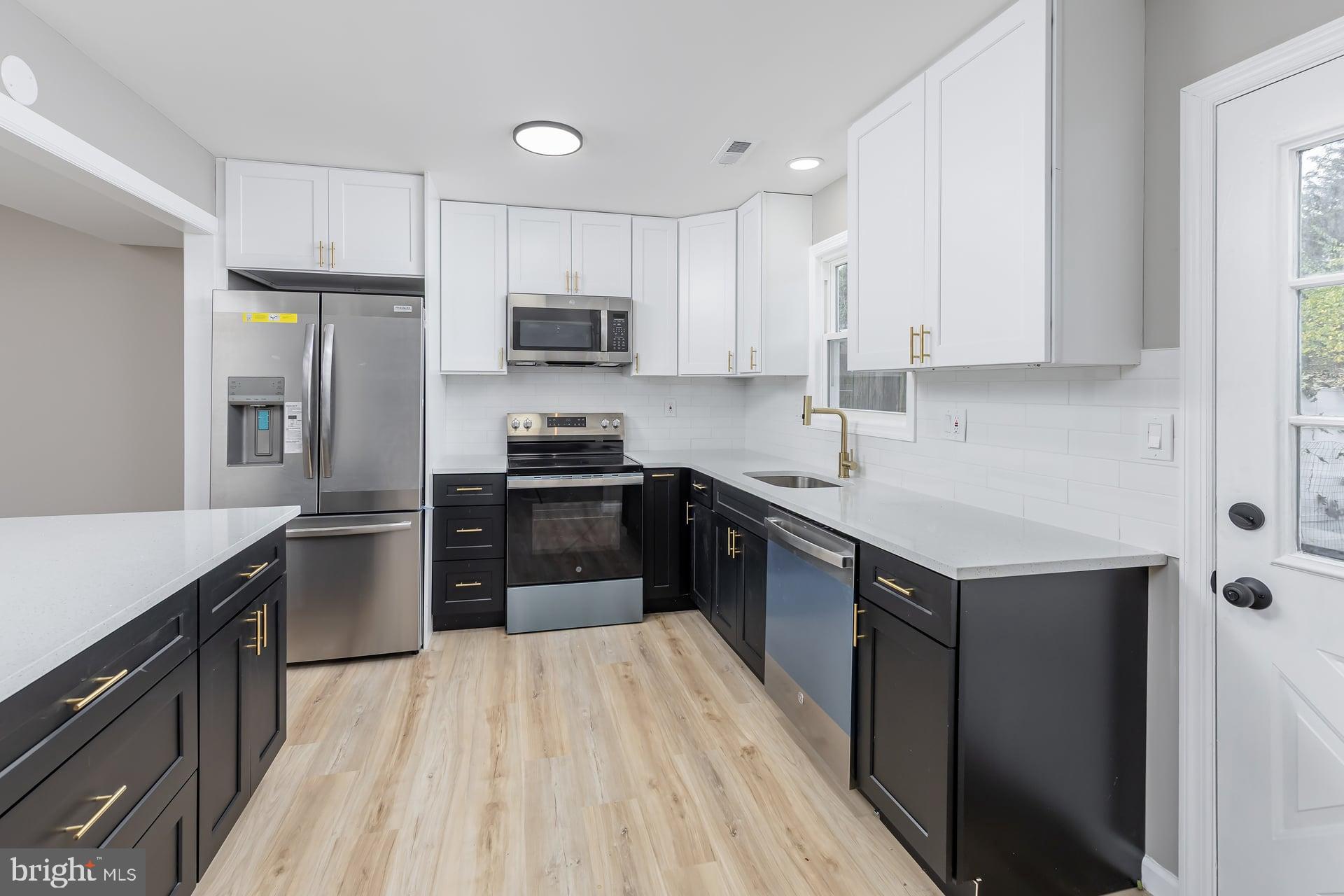 210 Stratton Court Mount Laurel, NJ 08054 - Photo 5 of 20 a kitchen with a sink a counter top space stainless steel appliances and cabinets